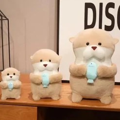 La compagnie de la peluche Peluche loutre tenant un poisson