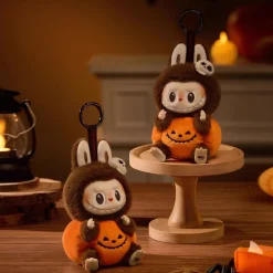 La compagnie de la peluche Peluche type Labubu marron et citrouille